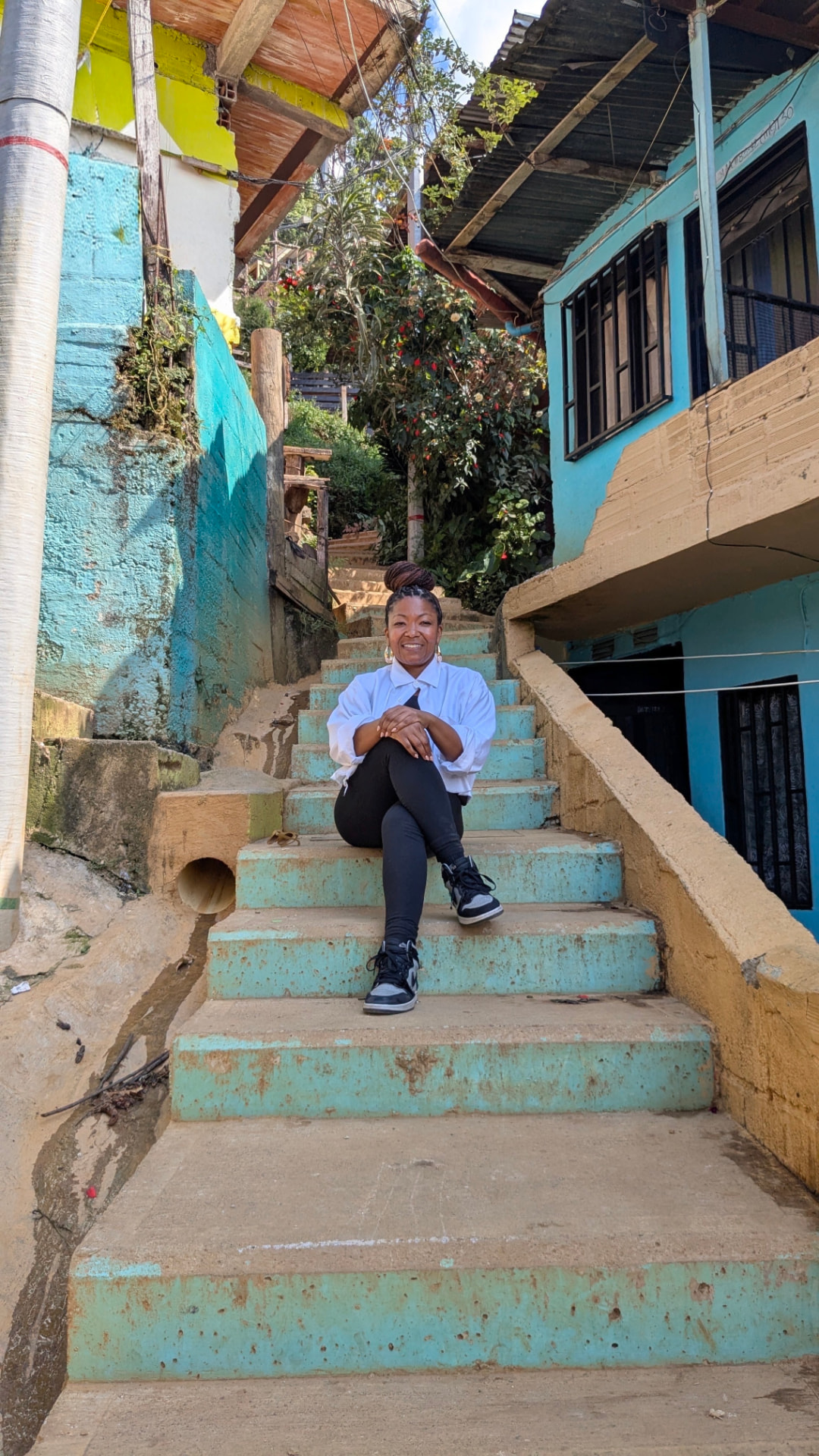 Ebony McMillian sitting on blue steps outdoors